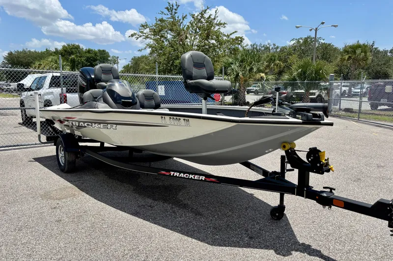 Slide: The Image of 2023 TRACKER MARINE Pro Team 175 TF boat on trailer in sunny outdoor setting. - 2