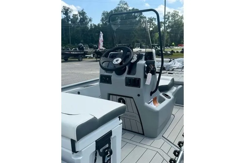 Slide: The Image of 2027 Tracker Bass Tracker Classic CC boat interior with steering console and seating. - 8