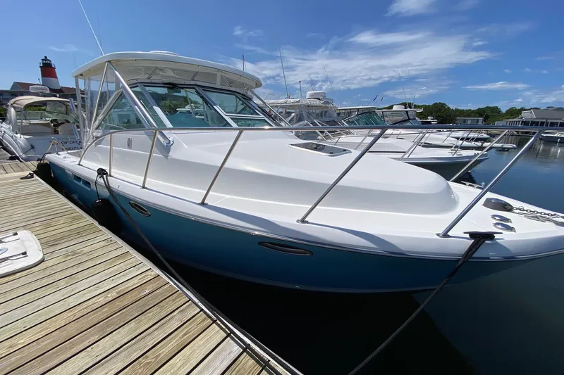 Slide: The Image of 2006 Tiara Yachts 2900 Open Classic docked at marina under clear blue sky. - 3