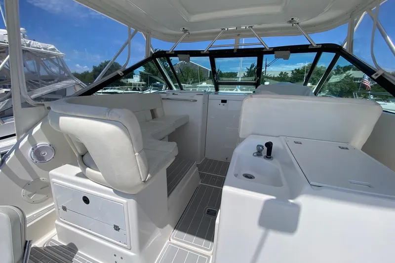 Slide: The Image of 2006 Tiara Yachts 2900 Open Classic interior with white seating and helm station. - 14