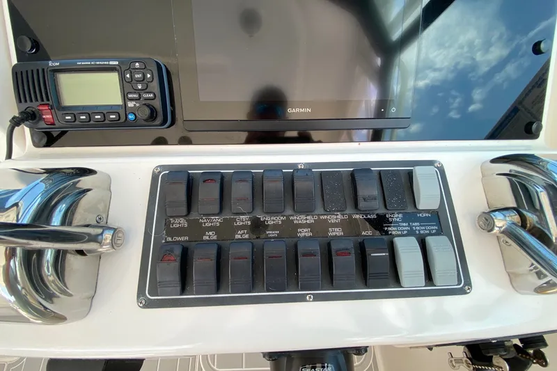 Slide: The Image of Control panel of a 2006 Tiara Yachts 2900 Open Classic with switches and navigation equipment. - 11