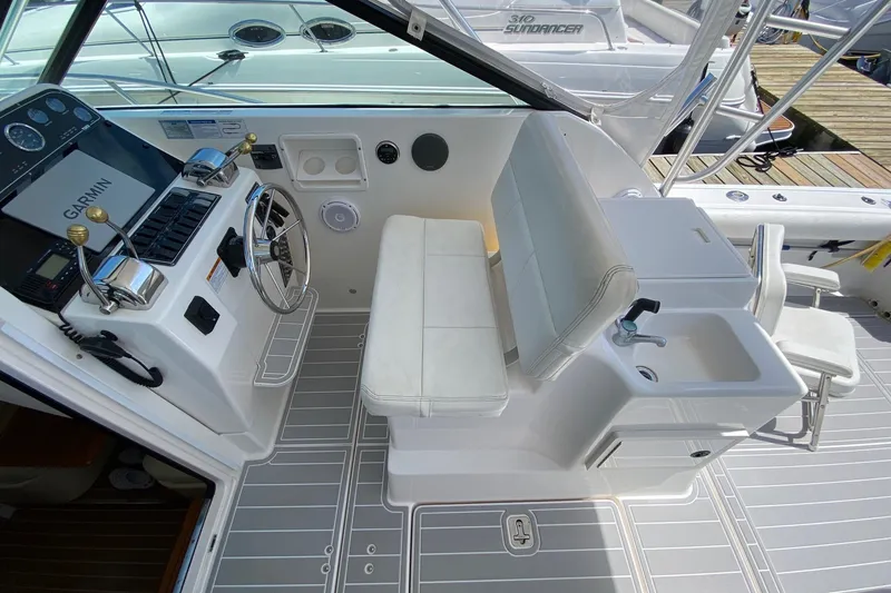 Slide: The Image of 2006 Tiara Yachts 2900 Open Classic cockpit with helm, Garmin system, and seating area. - 13