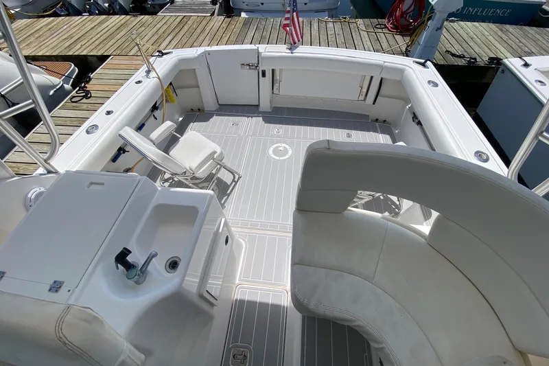 Slide: The Image of 2006 Tiara Yachts 2900 Open Classic boat interior with seating and sink, docked at marina. - 15