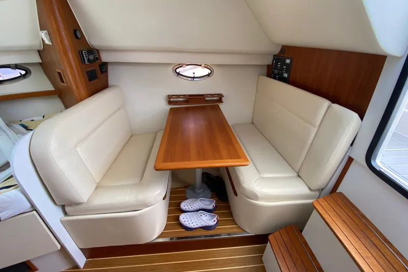 Slide: The Image of Interior of 2006 Tiara Yachts 2900 Open Classic with cozy seating and wooden table. - 24
