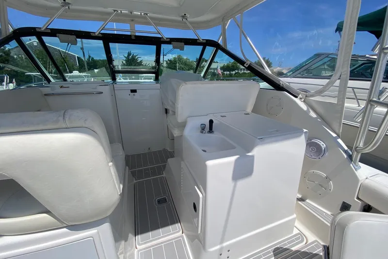 Slide: The Image of 2006 Tiara Yachts 2900 Open Classic interior with white seating and helm station. - 16