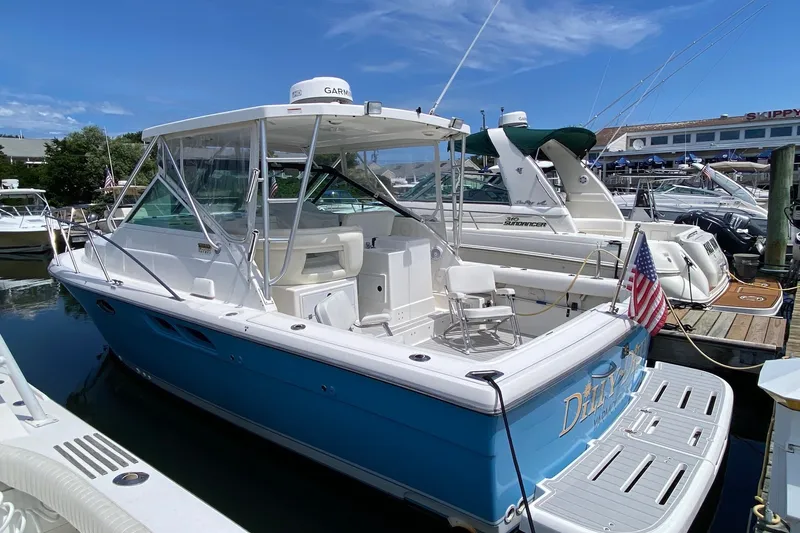 Slide: The Image of 2006 Tiara Yachts 2900 Open Classic docked, featuring a sleek design and American flag. - 2