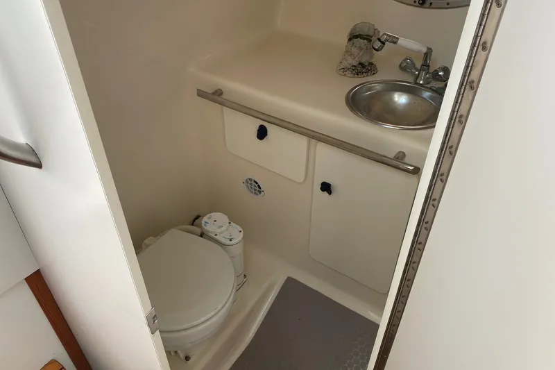 Slide: The Image of 2006 Tiara Yachts 2900 Open Classic bathroom with sink and toilet. - 30