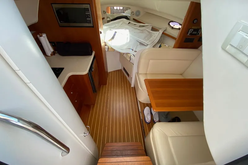 Slide: The Image of Interior of a 2006 Tiara Yachts 2900 Open Classic, featuring a cozy cabin layout. - 29