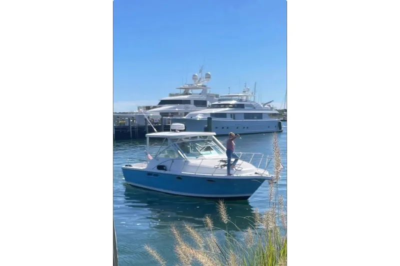Slide: The Image of 2006 Tiara Yachts 2900 Open Classic in marina, person on deck, sunny day. - 37