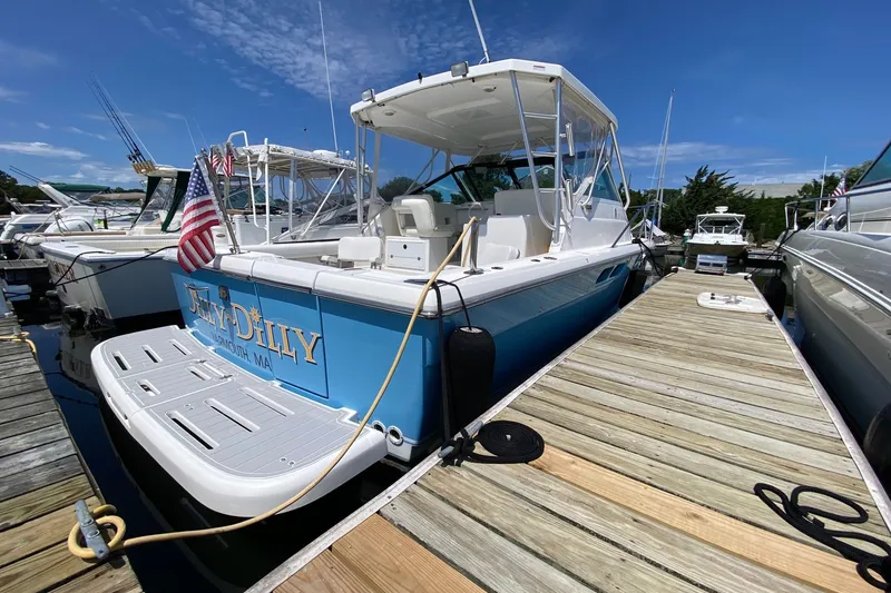 Slide: The Image of 2006 Tiara Yachts 2900 Open Classic docked, featuring a sleek design and American flag. - 6