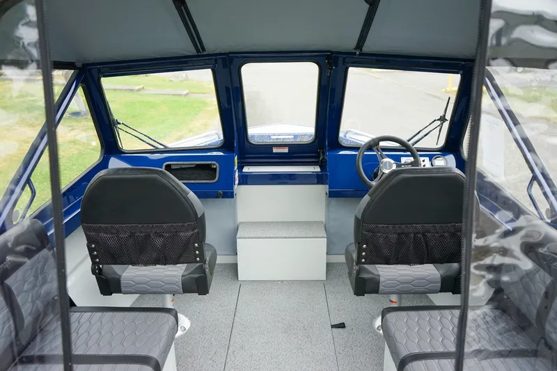 Slide: The Image of Interior of a 2027 Weldcraft 180 Rebel boat, featuring modern seating and steering. - 12