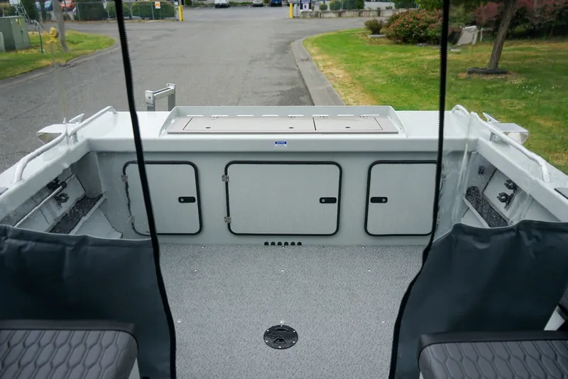 Slide: The Image of Interior view of a 2027 Weldcraft 180 Rebel boat, showcasing storage compartments and seating. - 6