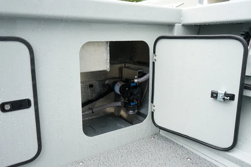Slide: The Image of Open compartment of 2027 Weldcraft 180 Rebel boat showing internal components and wiring. - 11