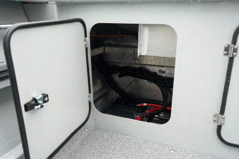 Slide: The Image of Open storage compartment in 2027 Weldcraft 180 Rebel boat, showing interior wiring and components. - 9