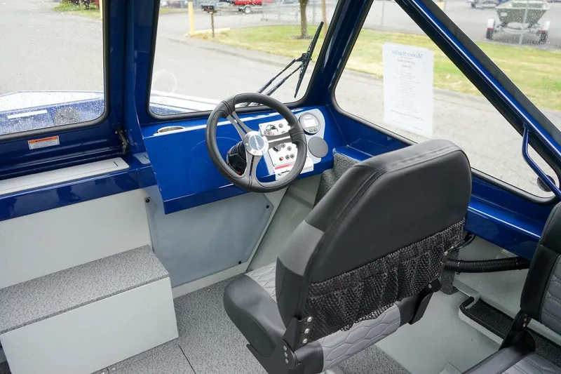 Slide: The Image of Interior of 2027 Weldcraft 180 Rebel boat, featuring steering wheel and dashboard controls. - 17