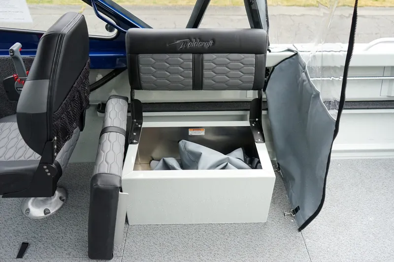 Slide: The Image of Interior of 2027 Weldcraft 180 Rebel boat with open storage compartment under seat. - 14