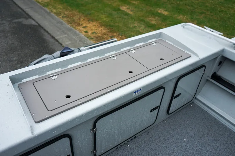 Slide: The Image of 2027 Weldcraft 180 Rebel boat storage compartments with secure latches and sleek design. - 7