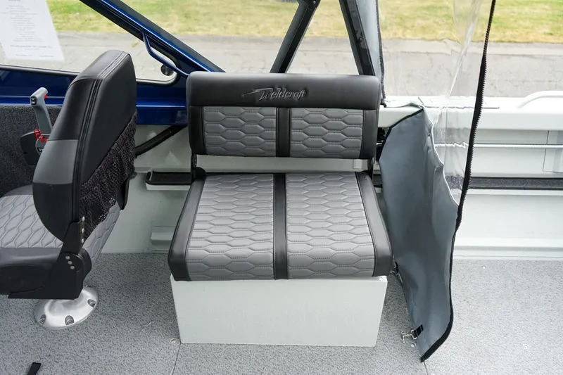 Slide: The Image of Interior seating of 2027 Weldcraft 180 Rebel boat with gray upholstery and modern design. - 13