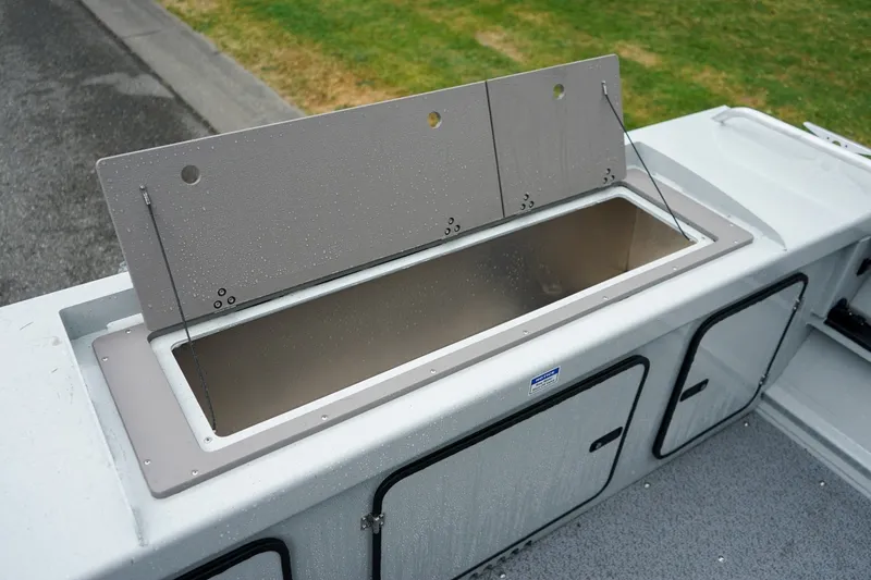 Slide: The Image of 2027 Weldcraft 180 Rebel boat storage compartment with open lid, showcasing spacious interior. - 8