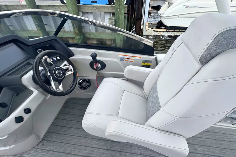Slide: The Image of 2022 Avalon Catalina Platinum boat interior with steering wheel and plush captain's chair. - 14