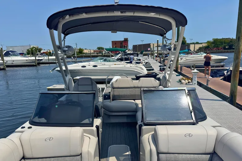 Slide: The Image of 2022 Avalon Catalina Platinum boat docked at marina with versatile rear bench. - 22
