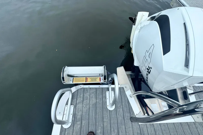 Slide: The Image of 2022 Avalon Catalina Platinum boat with rear bench and outboard motor on water. - 7