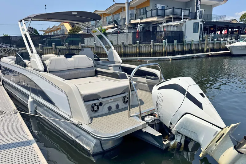 Slide: The Image of 2022 Avalon Catalina Platinum Versatile Rear Bench Windshield boat docked at marina. - 5