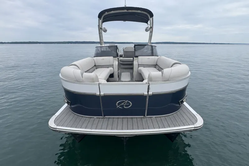 Slide: The Image of 2022 Avalon Catalina Platinum Versatile Rear Bench Windshield pontoon boat on calm water. - 3