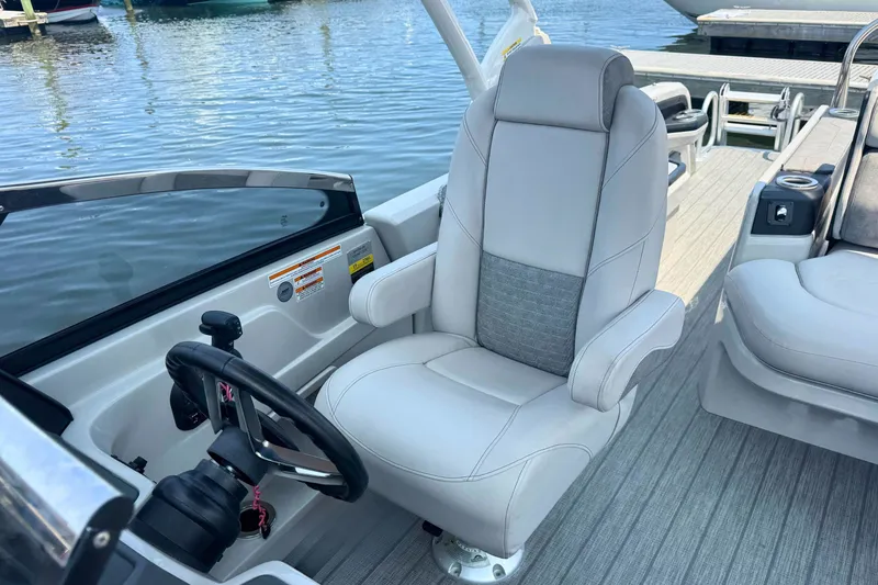 Slide: The Image of 2022 Avalon Catalina Platinum boat interior with plush captain's chair and steering wheel. - 15
