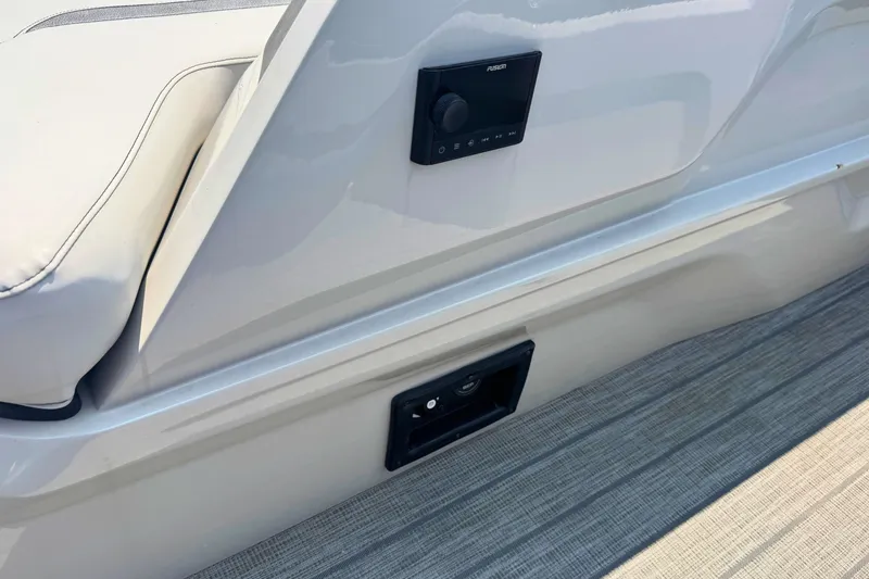 Slide: The Image of 2022 Avalon Catalina Platinum boat interior with control panel and cushioned seating. - 9