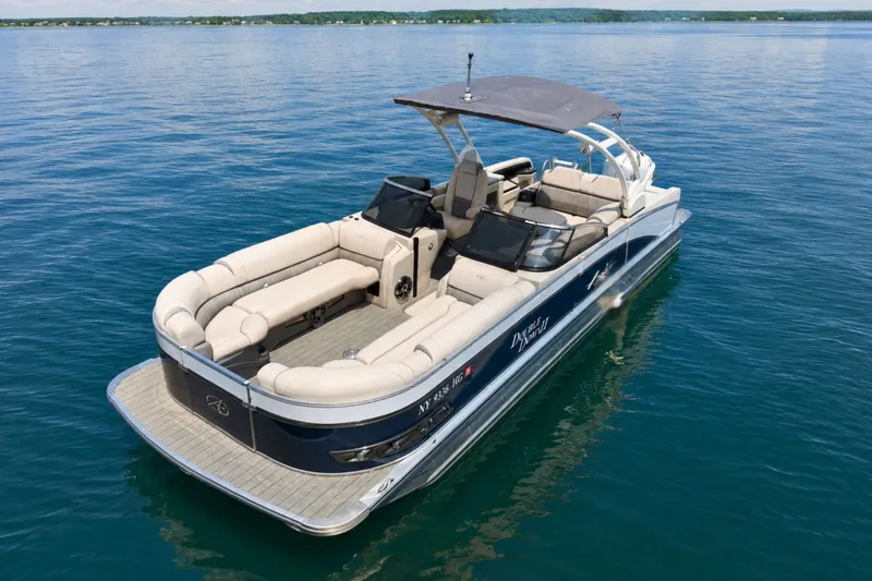 Slide: The Image of 2022 Avalon Catalina Platinum Versatile Rear Bench Windshield boat on calm water. - 4