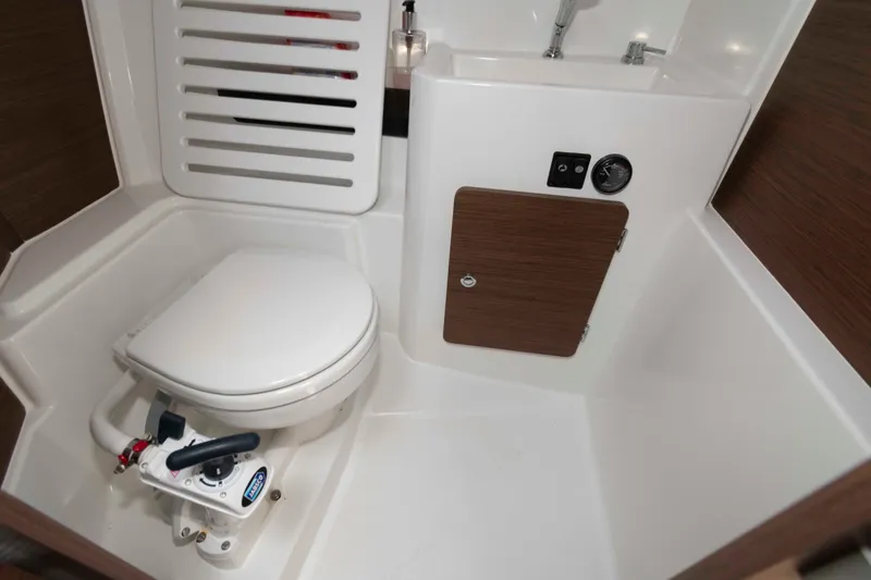 Slide: The Image of 2024 Jeanneau NC 795 Series 2 boat bathroom with toilet and sink. - 16