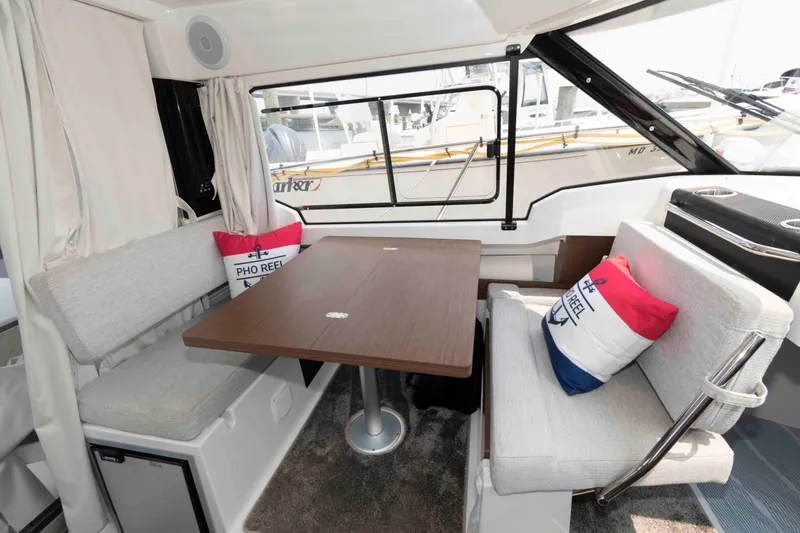 Slide: The Image of Interior of 2024 Jeanneau NC 795 Series 2 boat with cozy seating and table. - 11