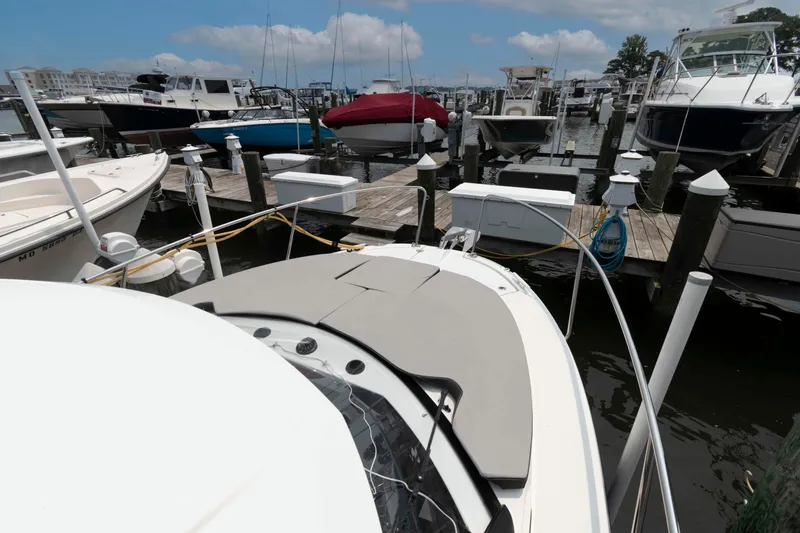 Slide: The Image of 2024 Jeanneau NC 795 Series 2 docked at a marina with other boats. - 6