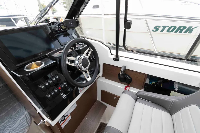 Slide: The Image of 2024 Jeanneau NC 795 Series 2 helm with modern controls and comfortable seating. - 13