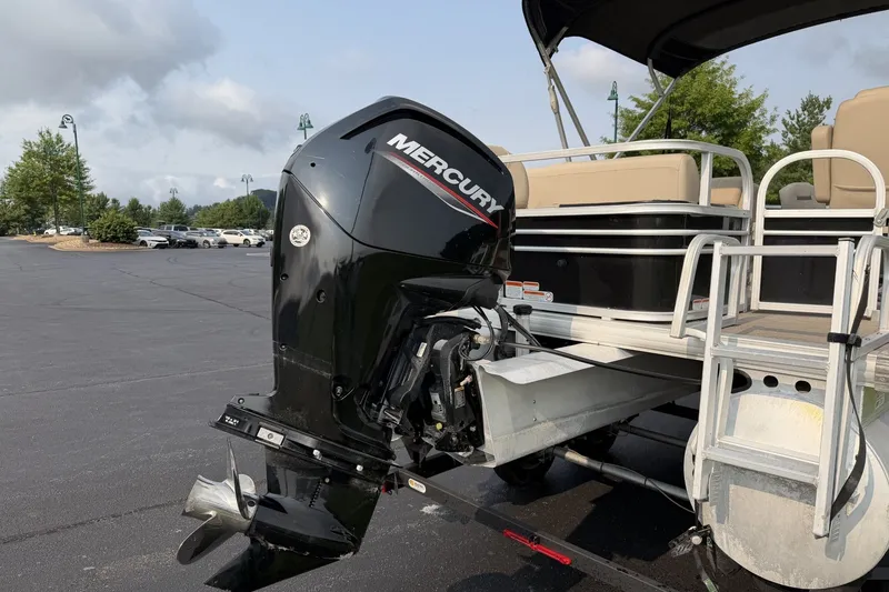 Slide: The Image of 2021 Sun Tracker Fishin' Barge 20 DLX with Mercury outboard motor in parking lot. - 3