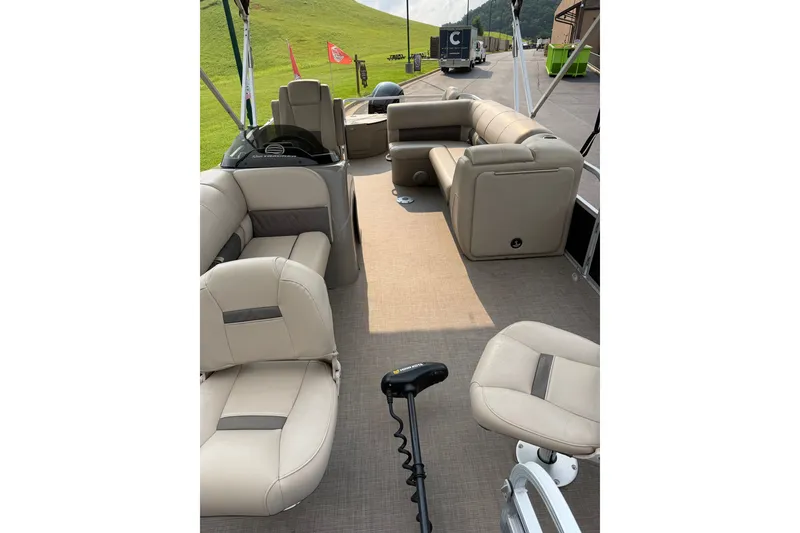 Slide: The Image of 2021 Sun Tracker Fishin' Barge 20 DLX interior with beige seating and fishing equipment. - 44