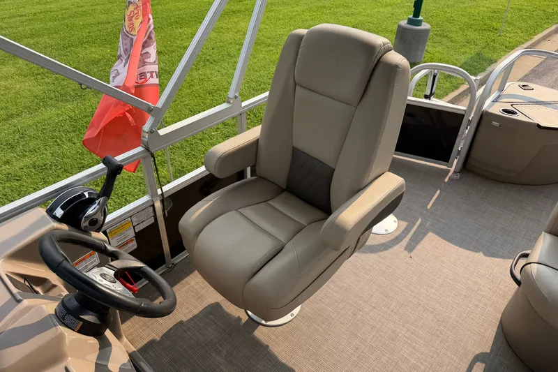 Slide: The Image of 2021 Sun Tracker Fishin' Barge 20 DLX captain's chair and steering wheel, with red flag. - 16