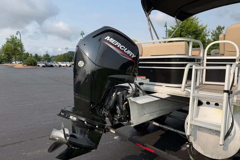 Slide: The Image of 2021 Sun Tracker Fishin' Barge 20 DLX with Mercury outboard motor in parking lot. - 33