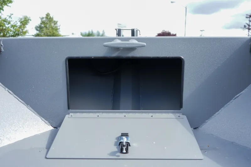 Slide: The Image of 2026 Alumaweld Adventurer 20 boat storage compartment with latch, showcasing durable construction. - 15
