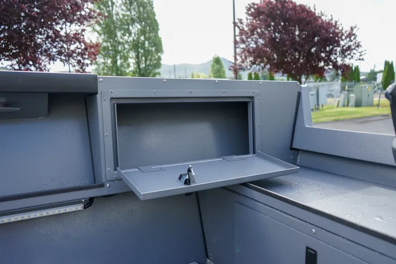 Slide: The Image of 2026 Alumaweld Adventurer 20 boat storage compartment with open hatch, showcasing sleek design. - 9