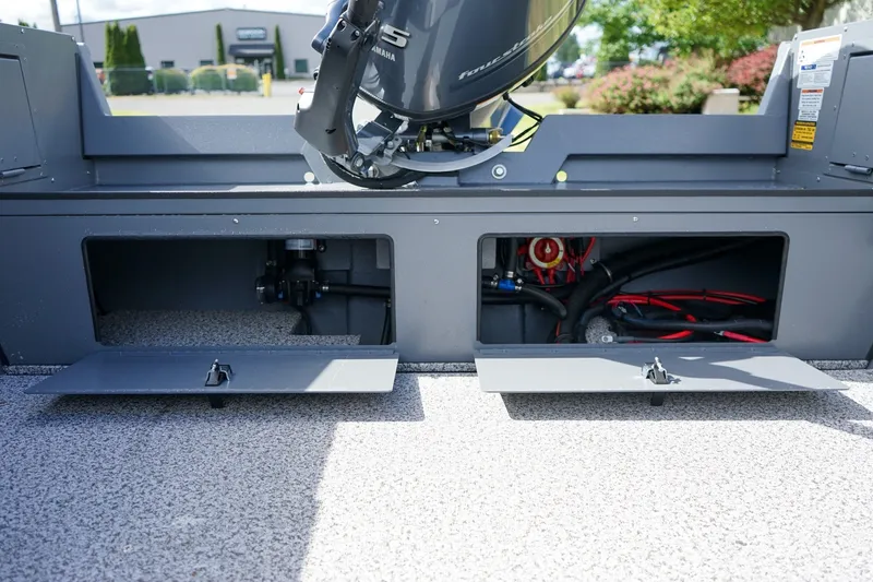 Slide: The Image of 2026 Alumaweld Adventurer 20 boat compartments with Yamaha motor, showcasing storage and wiring. - 7