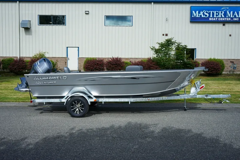 Slide: The Image of 2026 Alumaweld Adventurer 20 boat on trailer, parked outside Master Marine Boat Center. - 2