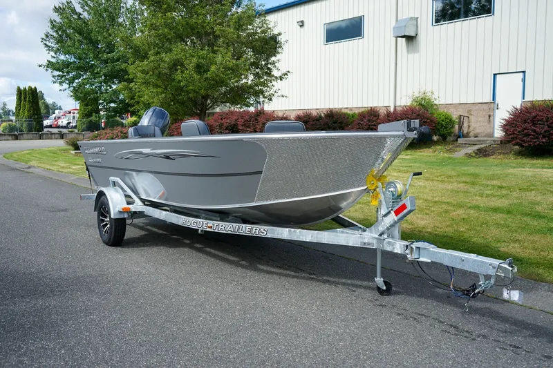 The Image of 2026 Alumaweld Adventurer 20 boat on a Rogue trailer, parked outdoors. - 1