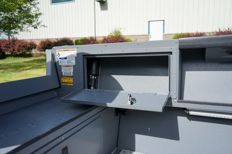 Slide: The Image of 2026 Alumaweld Adventurer 20 boat storage compartment with open hatch, showcasing interior details. - 8