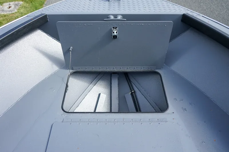 Slide: The Image of 2026 Alumaweld Adventurer 20 boat storage compartment, open hatch, gray interior. - 14