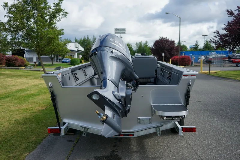 Slide: The Image of 2026 Alumaweld Adventurer 20 boat with Yamaha outboard motor, parked on a paved road. - 4