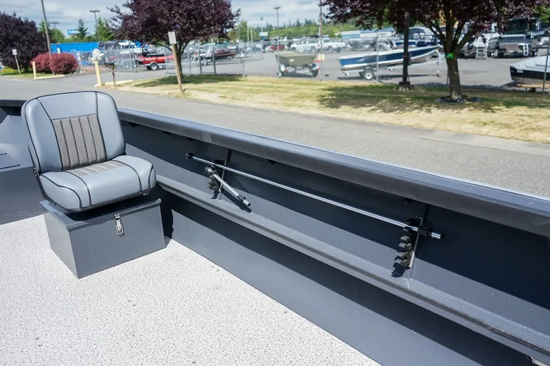 Slide: The Image of 2027 Alumaweld Adventurer 20 boat interior with seating and rod holder, parked outdoors. - 12