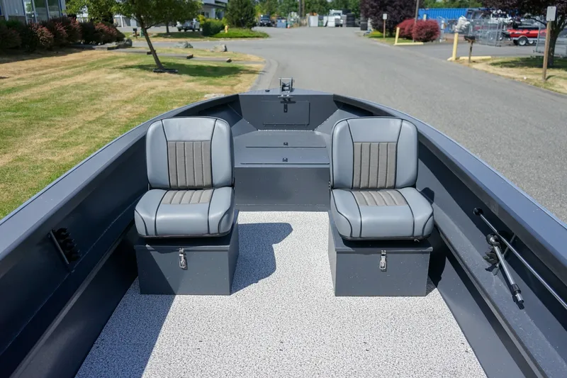 Slide: The Image of 2027 Alumaweld Adventurer 20 boat interior with two gray seats on a sunny day. - 13