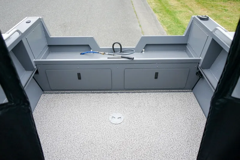 Slide: The Image of Interior view of 2026 Alumaweld Stryker Sport 202 boat, featuring storage compartments and clean deck. - 6
